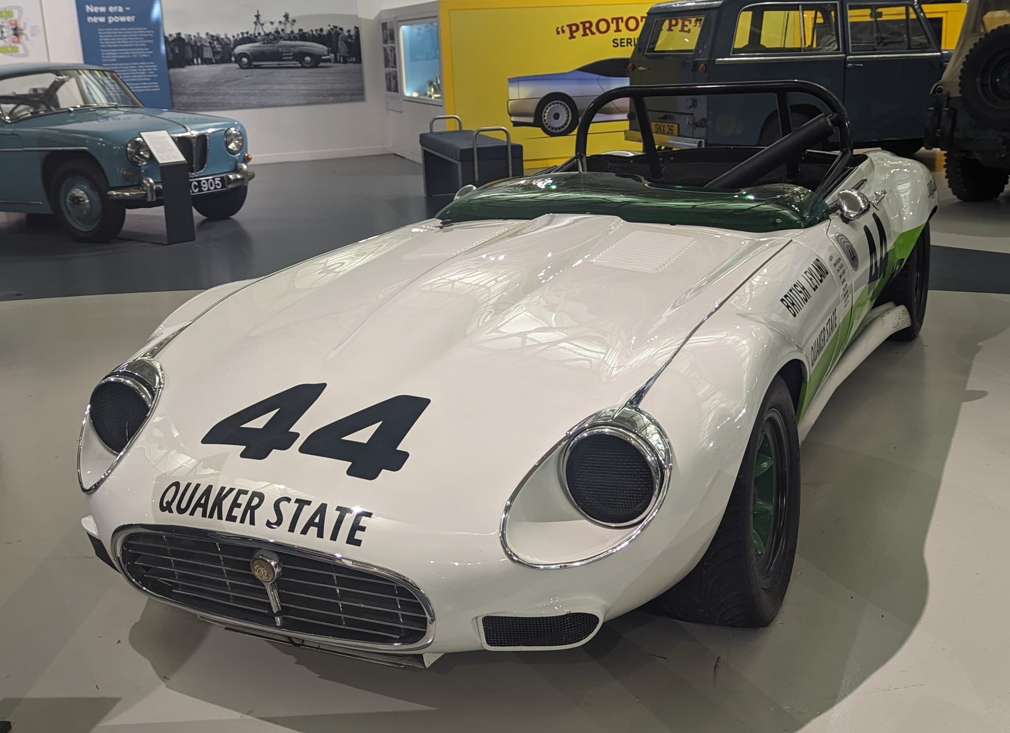 The front of a white E-Type V12 race car with the number 44 and Quaker State lettering.