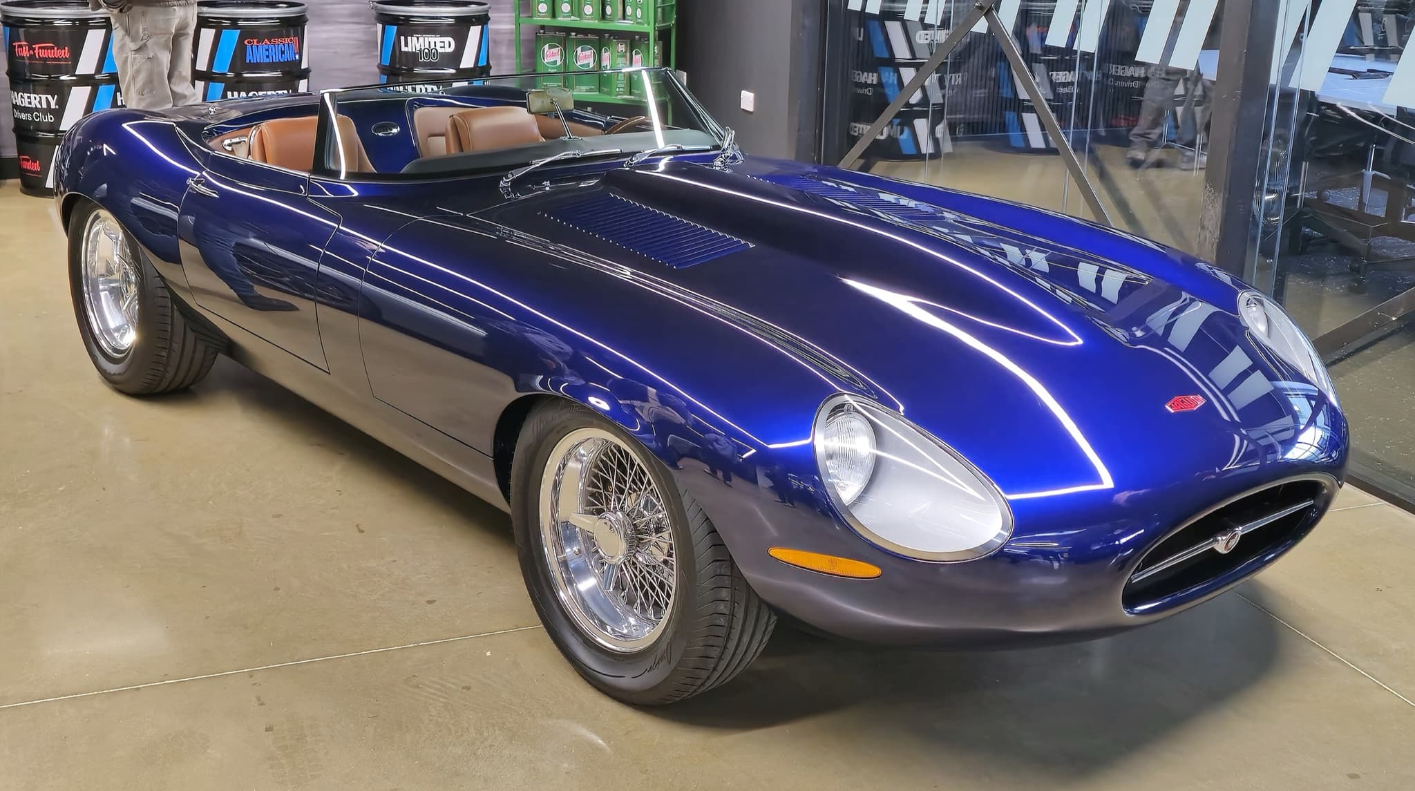 A dark blue Eagle Speedster with a low raked screen and tan seats on a polished concrete floor.