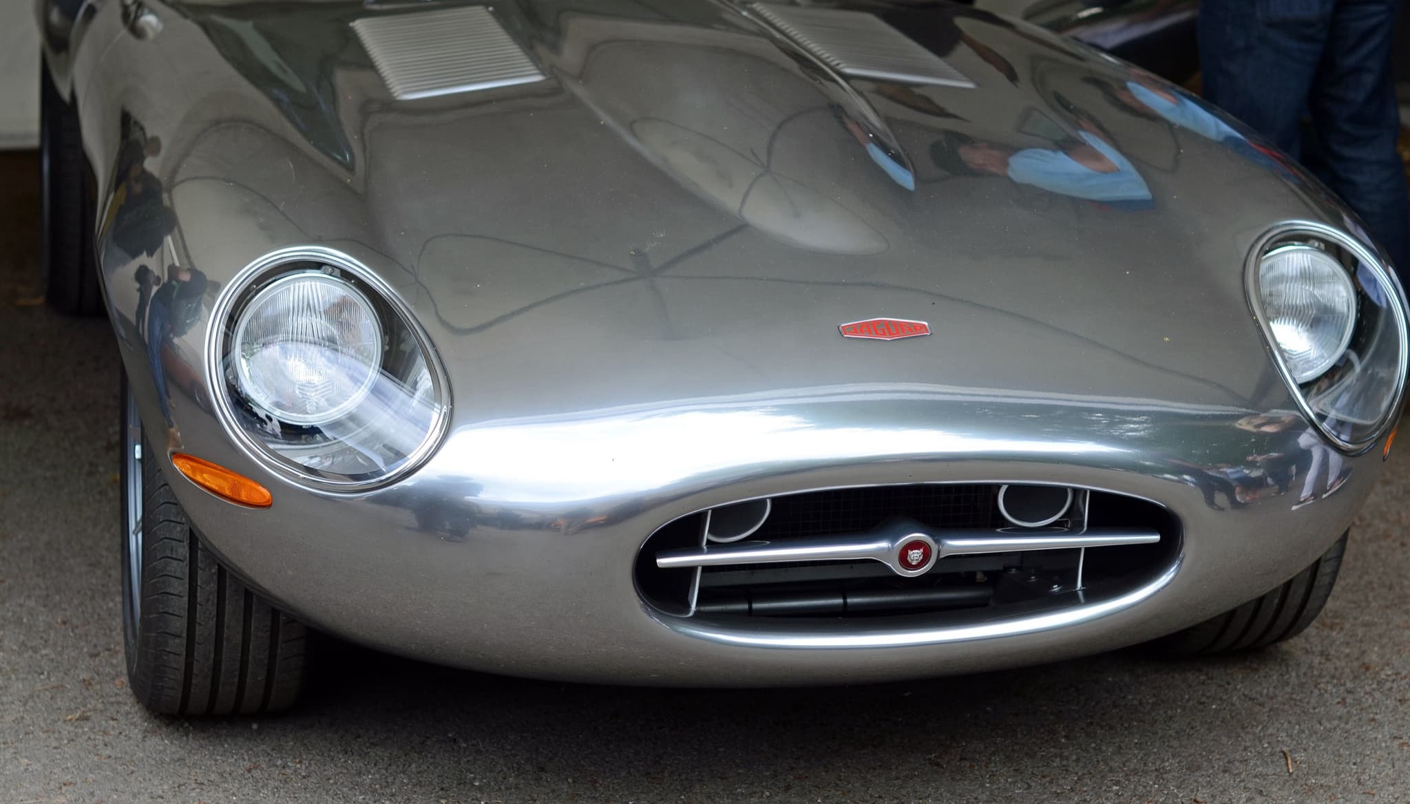 The polished bare-aluminium nose of an Eagle Spyder GT, with covered headlamps and a small oval intake.